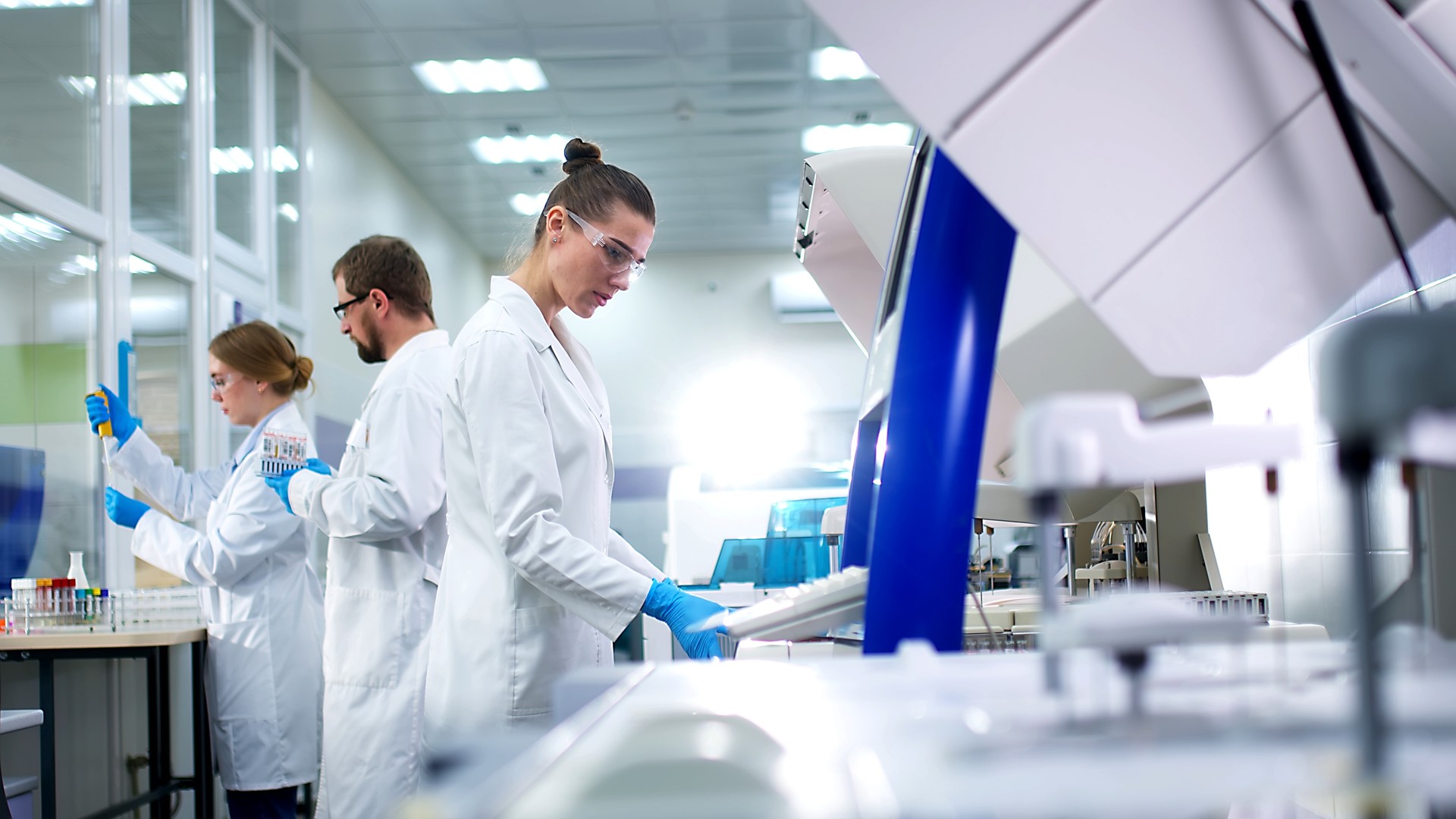 A medical research laboratory with a diverse team of biochemical scientists working with computers and modern medical technologies. Development of high-tech equipment for medicines.