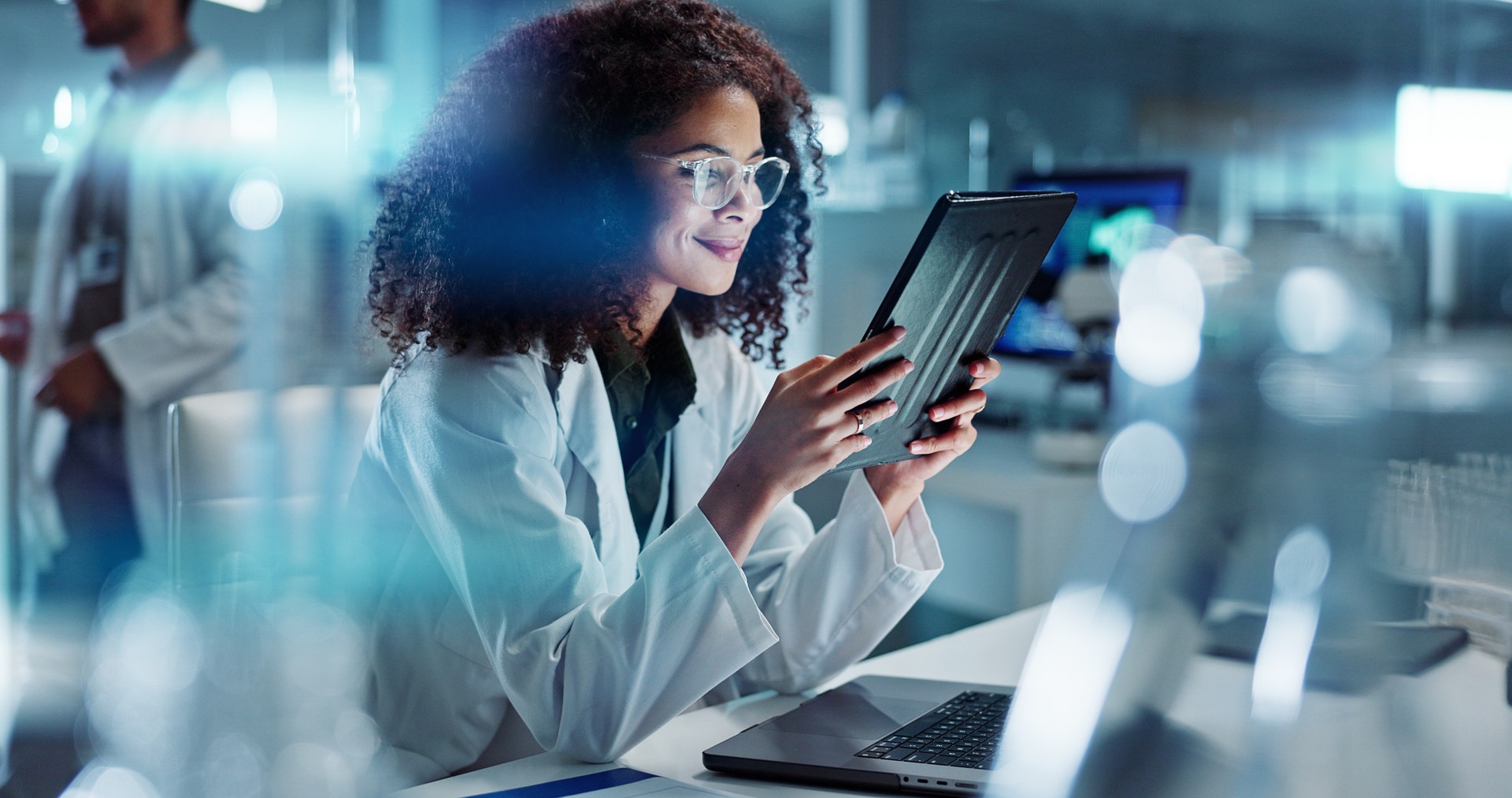 Tablet, night or scientist with research in laboratory for chemistry report or scientific test feedback. Medical health, happy woman typing or science update for online medicine development news